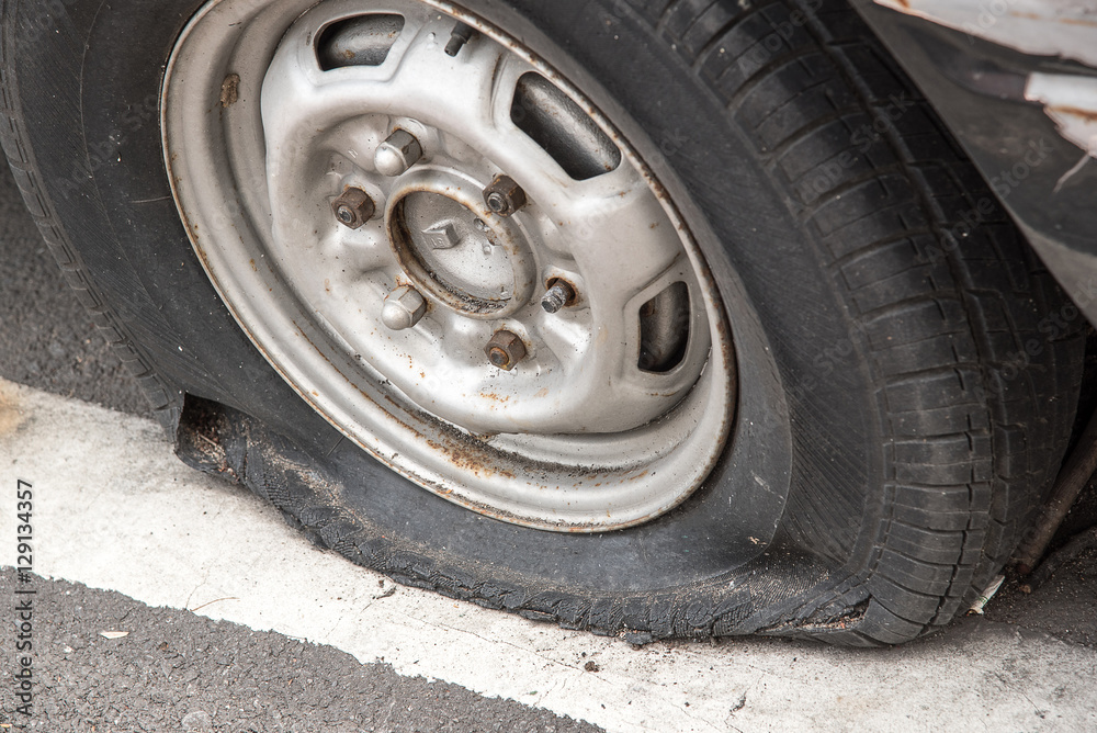 Old rusty wrecked car with a punctured tire. Old rusty wrecked car with a punctured tire.