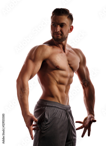 Bodybuilder posing on a white background. Athlete isolated. Drying. Relief and sculptural muscles of the body. Healthy lifestyles concept. The beauty of the male body.