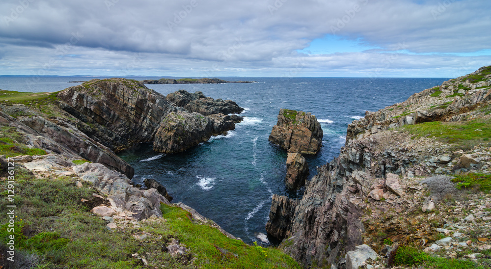 Cape Bonavista featuring coastal slabs of stone boulders and rocks that show their layers of formation over millions of years.  Rocky boulder shoreline in Newfoundland, Canada.