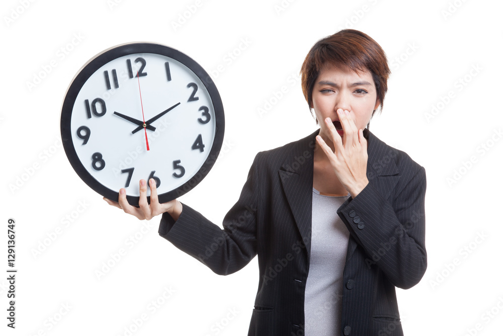 Sleepy young Asian business woman with a clock in the morning. Sleepy young Asian business woman with a clock in the morning.