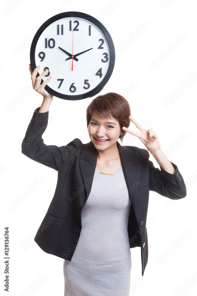 Young Asian business woman show victory sign with a clock. Young Asian business woman show victory sign with a clock.