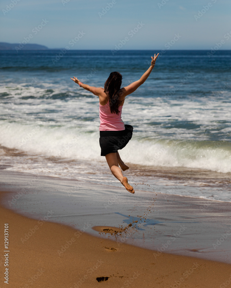Girl Jumping Beach - Tasmania, Australia Girl Jumping Beach - Tasmania, Australia