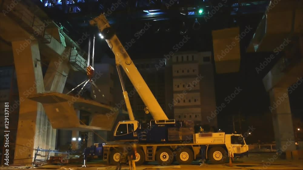 Big crane lifting large cement bar up at express way construction site in Bangkok, Thailand