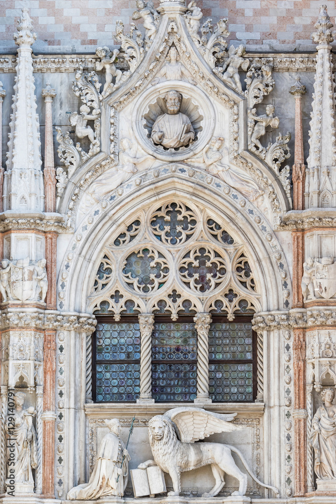 Architectural detail of Basilica of Saint Mark (Venice, Italy). Vertically. Closeup view of sculpture of Doge and Venetian lion.