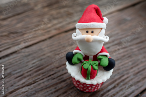 christmas theme cup cake on wooden background