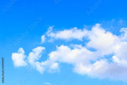 Blue sky background with white clouds and rain clouds. The vast blue sky and clouds sky on sunny day. White fluffy clouds in the blue sky.