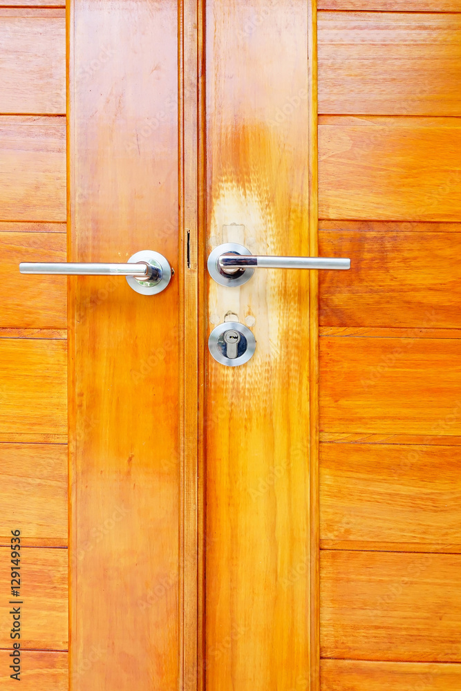 Obraz premium Close up brown modern wooden door with handle