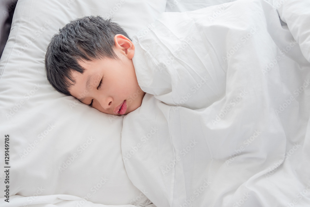 Young Asian boy sleeping on bed Young Asian boy sleeping on bed