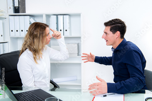 young businessman and businesswoman in conflict