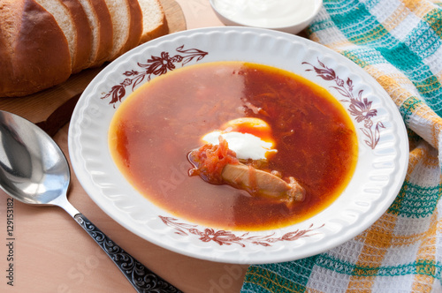 Plate of delicious soup from beet with sour cream and chicken 