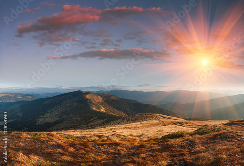 Panoramic landscape in the autumn mountains at sunset.