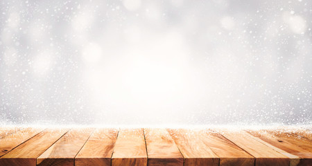 .Empty wood table top with snowfall of winter season background.