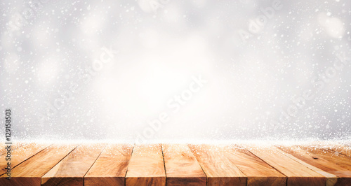 .Empty wood table top with snowfall of winter season background.