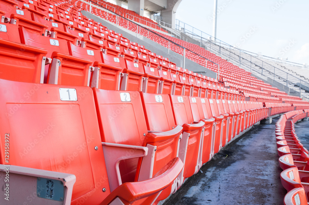 Fototapeta premium Empty orange seats at stadium,Rows of seat on a soccer stadium