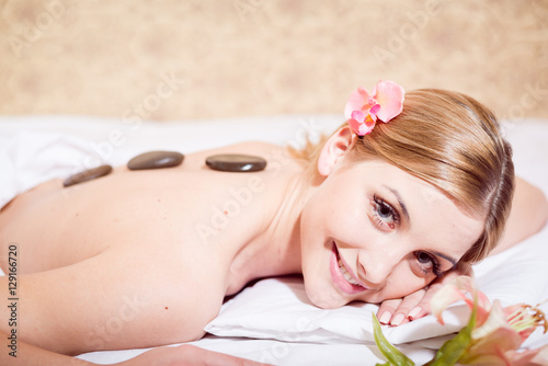 Young Caucasian woman getting a hot stone massage