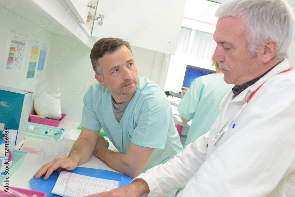 Fototapeta premium two doctors at hospital with clipboard