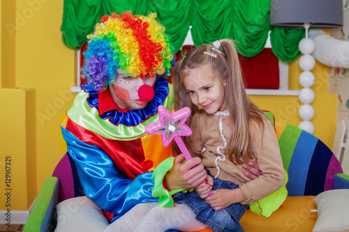Girl playing with cheerful clown