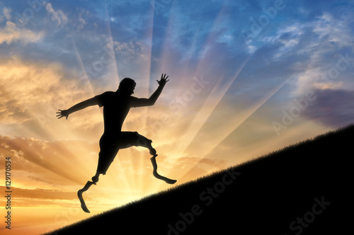 Wallpaper Mural Disabled athlete with prosthetic legs to climb up sunset Torontodigital.ca