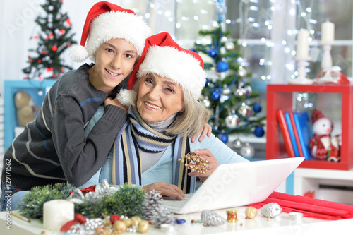 Grandmother with grandson preparing for Christmas