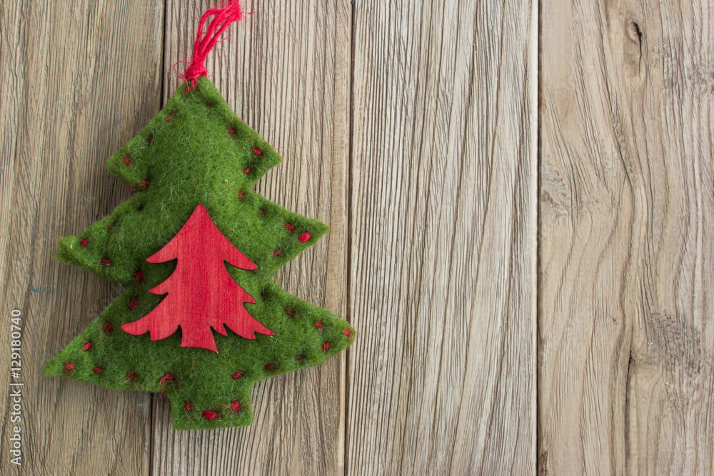 Toy Christmas tree made of felt on the wooden table Toy Christmas tree made of felt on the wooden table