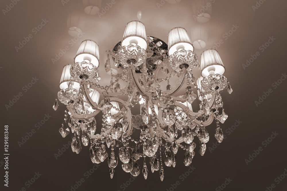 large modern chandelier with crystal pendants and glowing bulbs large modern chandelier with crystal pendants and glowing bulbs