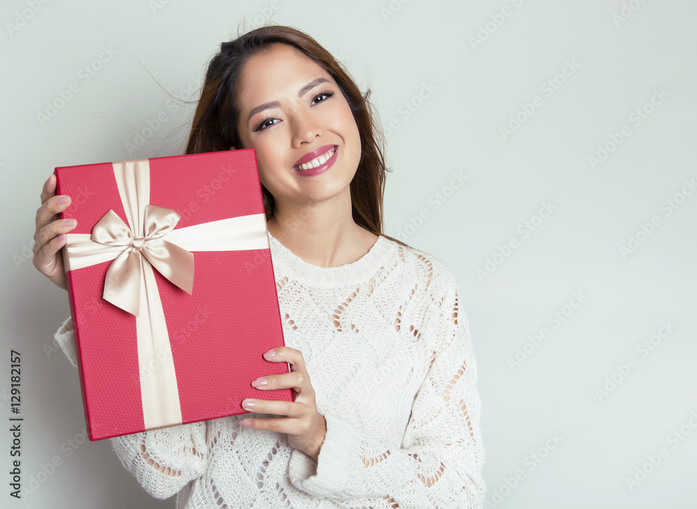 beautiful young asian woman holding a present beautiful young asian woman holding a present