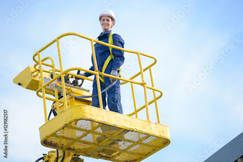 Woman in cherry picker bucket photo