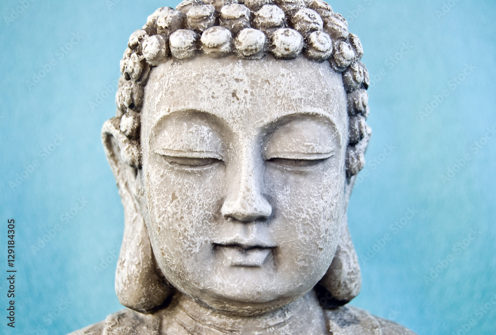 Buddha face on blue background.