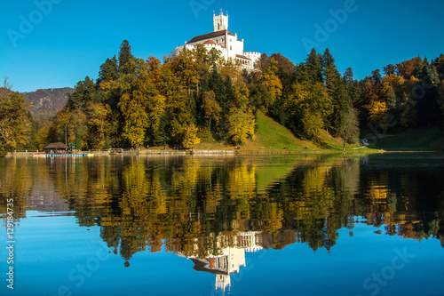 Castle of Trakoscan on the hill in autumn, Zagorje, Croatia, reflection on the lake photo