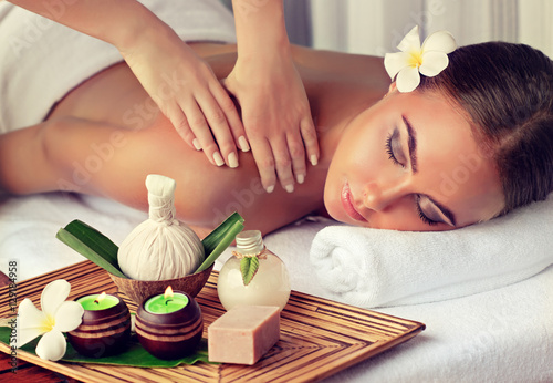 Body care. Spa body massage treatment. Woman having massage in the spa salon photo