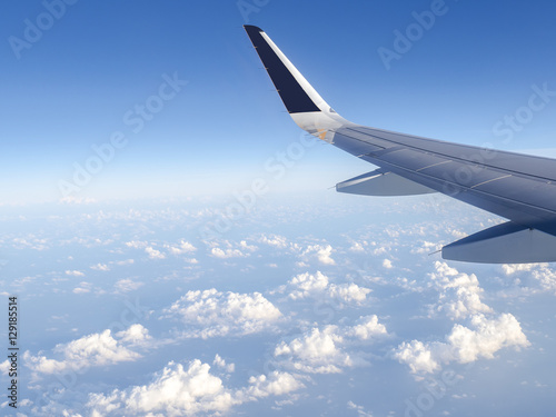 Wing of airplane fly over the blue sky and white cloud 3