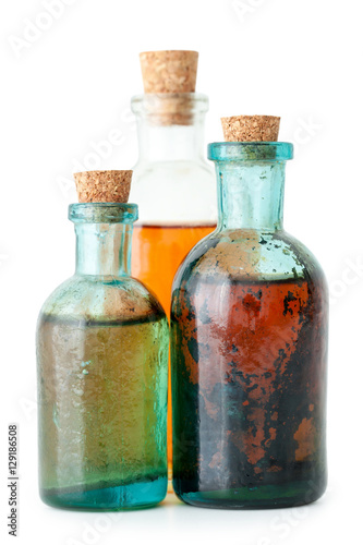 Three bottles of herbal infusion or essential oil closeup 