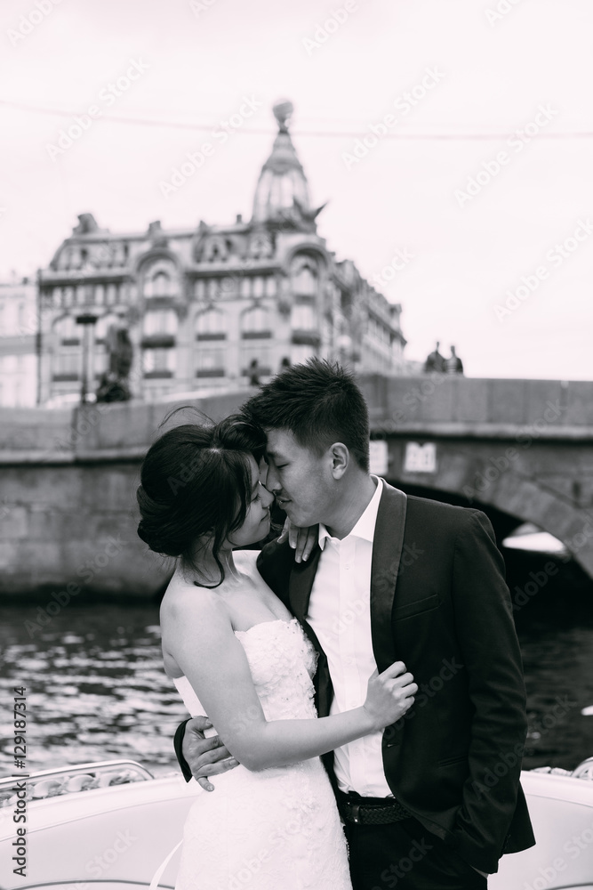 Bride and groom are floating on a boat on the city's rivers and canals