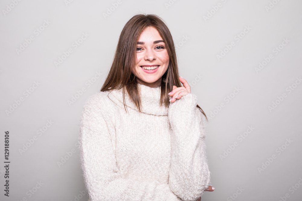 Pretty model in sweater in studio isolated gray background Pretty model in sweater in studio isolated gray background