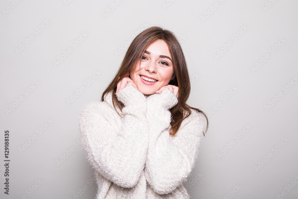 Pretty model in sweater in studio isolated gray background Pretty model in sweater in studio isolated gray background