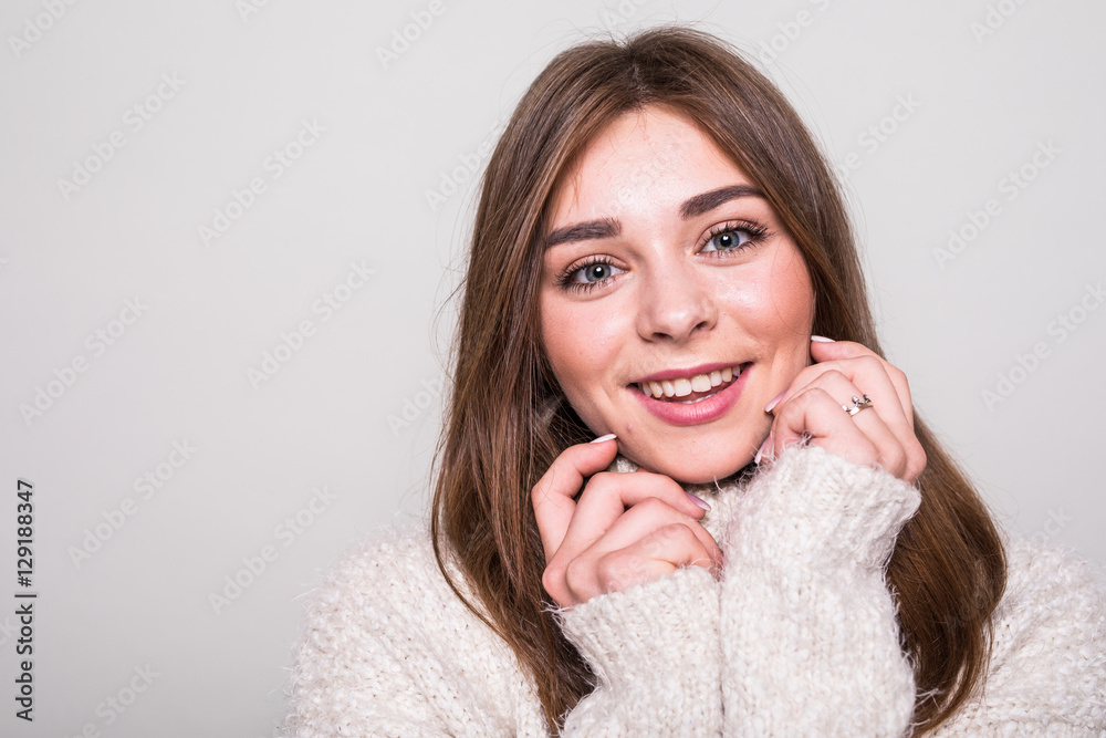 Pretty model in sweater in studio isolated gray background Pretty model in sweater in studio isolated gray background
