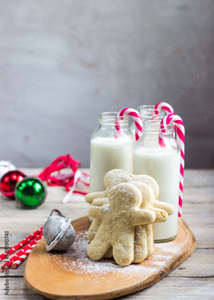 Milk in the bottles and cookies on rustic wood table. C Milk in the bottles and cookies on rustic wood table. C
