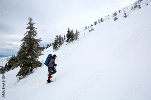 Man hiking in winter mountains