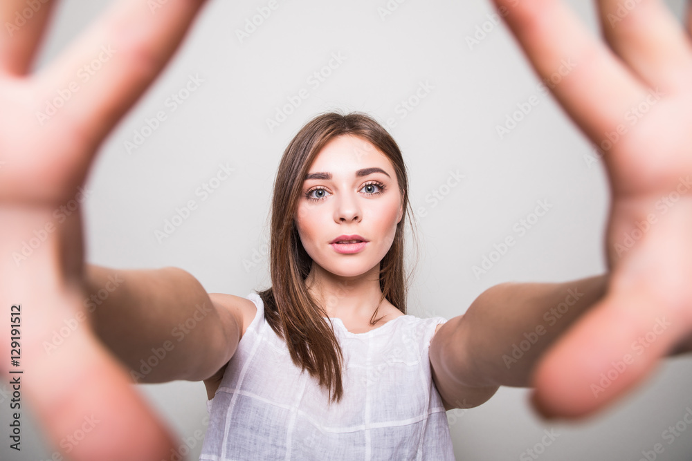 young girl making selfie on a gray background young girl making selfie on a gray background