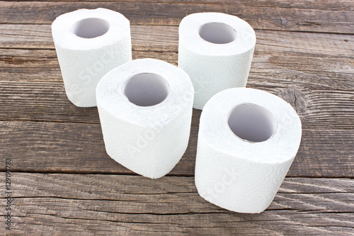 Toilet paper rolls on wood background