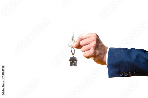 businessman presenting the house key isolated on white background