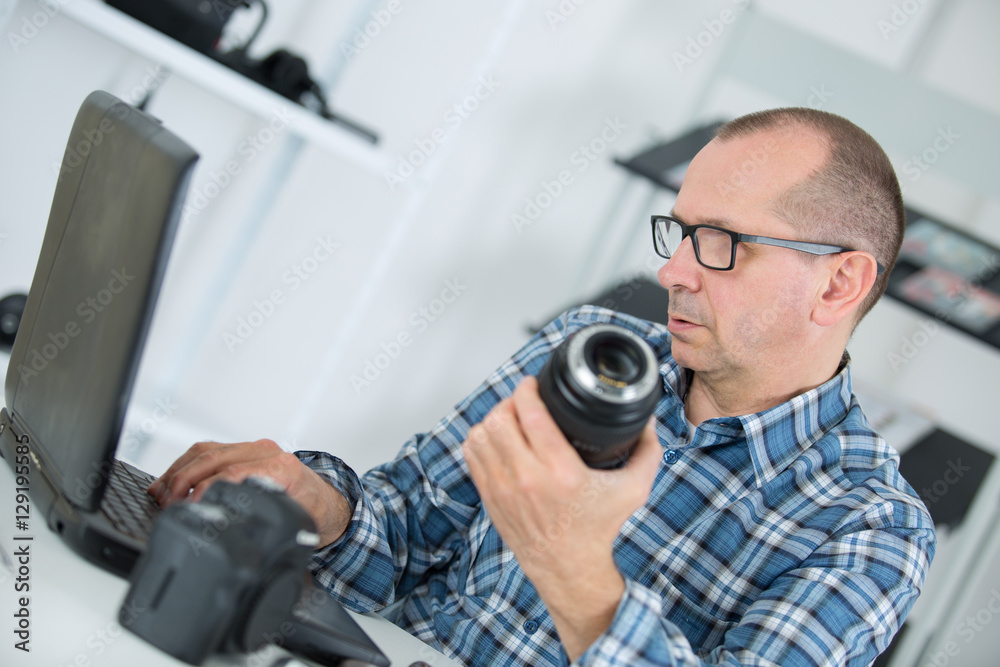 technician examining and repairing dslr camera technician examining and repairing dslr camera