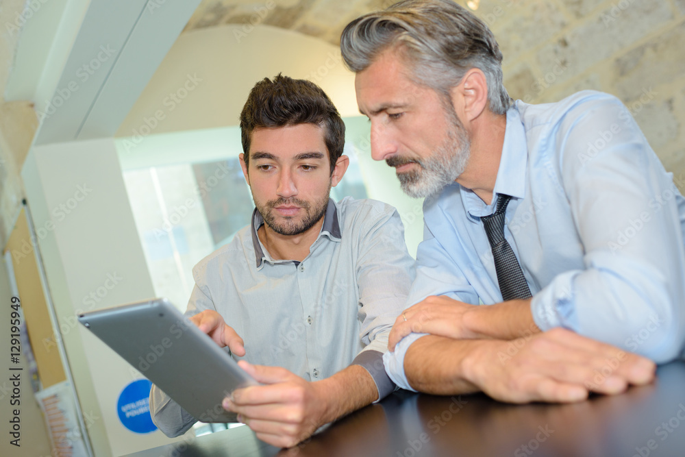 Fototapeta premium business executive and co-worker using digital tablet in office