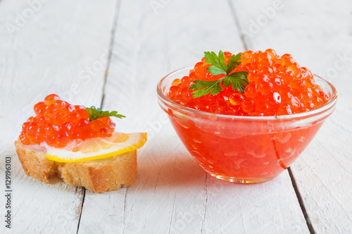 Red caviar on bread with lemon and parsley