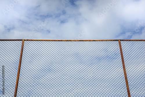 steel fence with cloud and blue sky