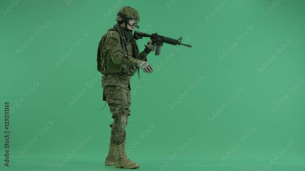 Soldier moving his hands and weapon at green screen Soldier moving his hands and weapon at green screen
