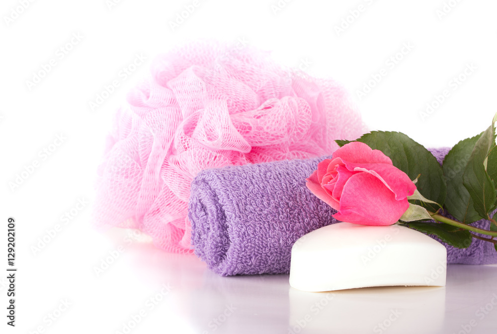Wash cloth, shower puff, soap and pink rose on light background Wash cloth, shower puff, soap and pink rose on light background