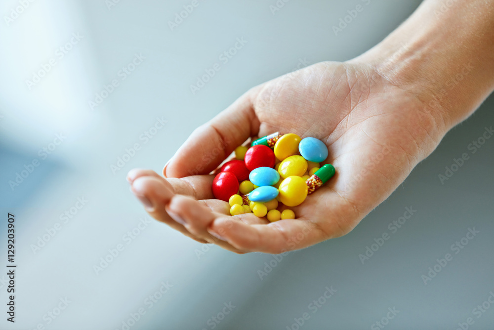 Vitamins And Supplements. Female Hand With Colorful Pills Vitamins And Supplements. Female Hand With Colorful Pills