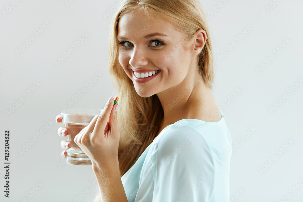 Beautiful Smiling Woman Taking Vitamin Pill. Dietary Supplement Beautiful Smiling Woman Taking Vitamin Pill. Dietary Supplement