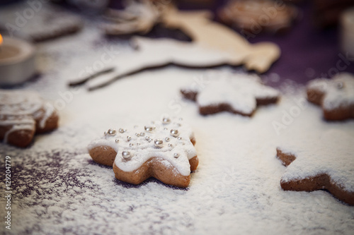 Christmas gingerbread cookie tree with flour on purple backgroun